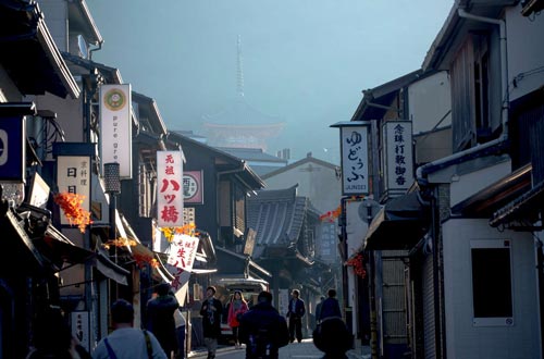 The busy streets of Kyoto are just waking up; the morning sun rises on the road to Kiyomizu.